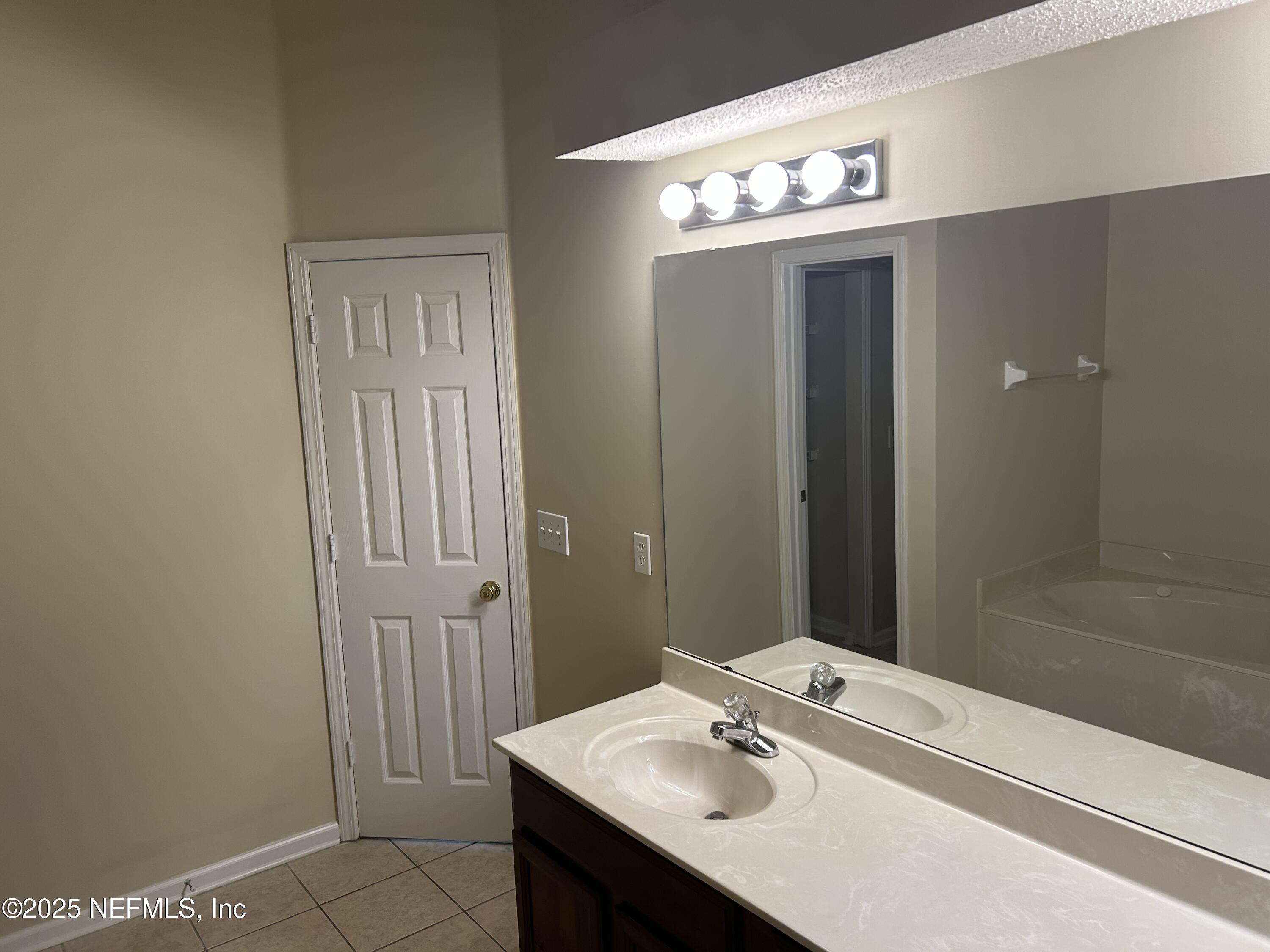 1425 Laurel Oak Drive Fleming Island, FL 32003 - Photo 13 of 25 a bathroom with a sink and a mirror