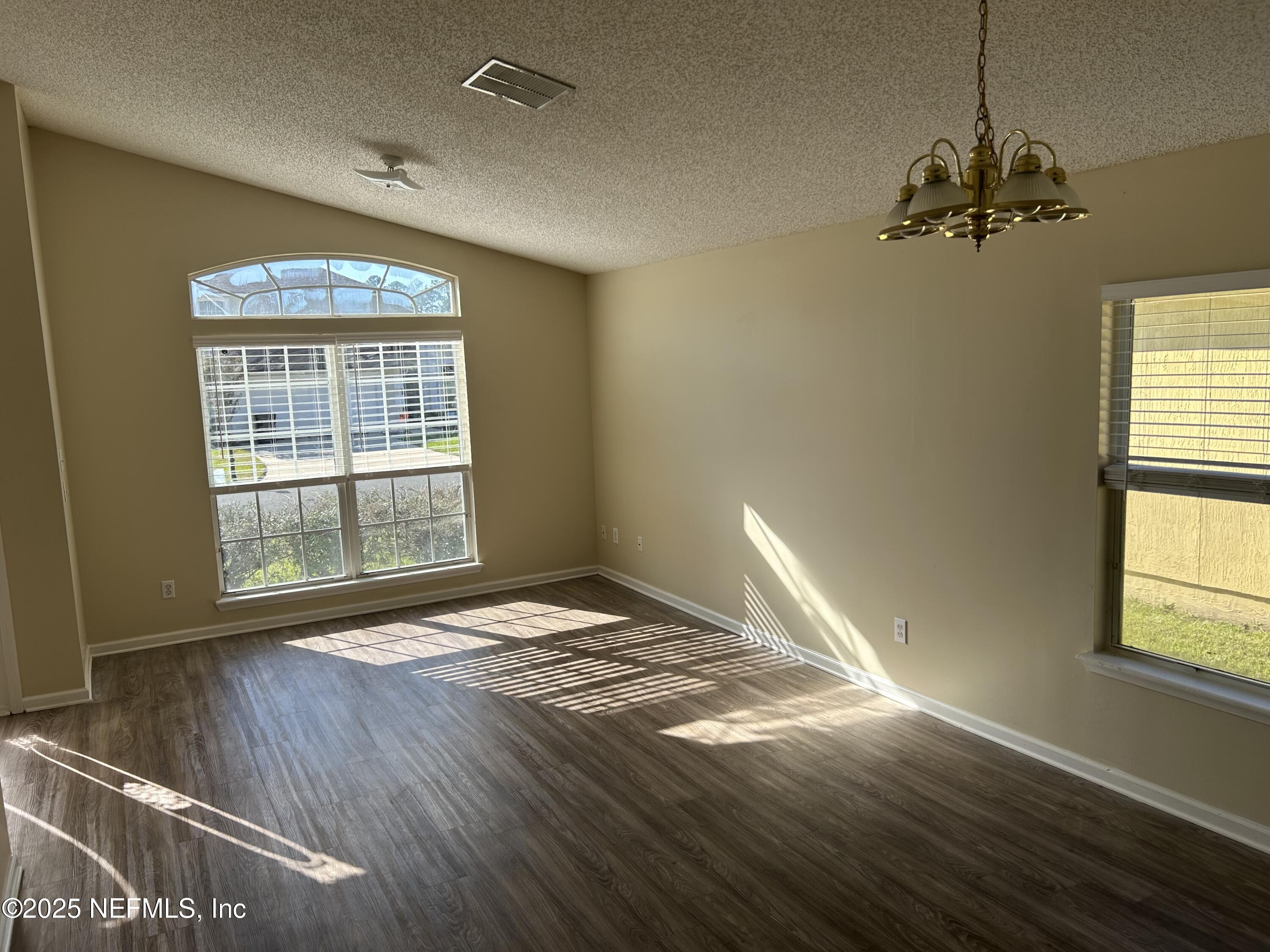 1425 Laurel Oak Drive Fleming Island, FL 32003 - Photo 4 of 25 a view of an empty room with wooden floor and a window