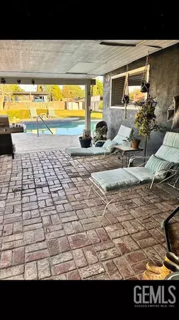 a view of swimming pool with outdoor seating