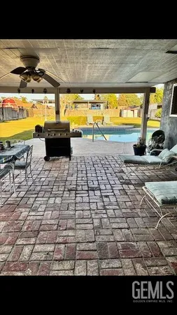 a view of a swimming pool with an outdoor space and seating