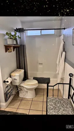 a view of bathroom with a toilet a sink and a mirror