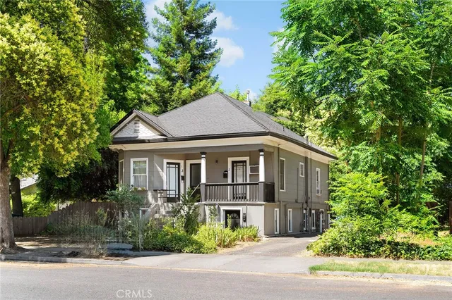 a house that has a tree in front of it