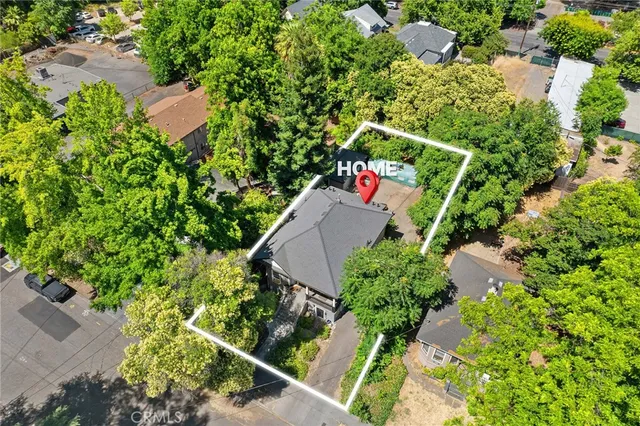 an aerial view of a house with a yard and outdoor seating