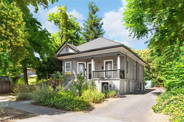a front view of a house with a garden