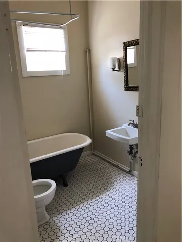 a bathroom with a toilet a sink and mirror
