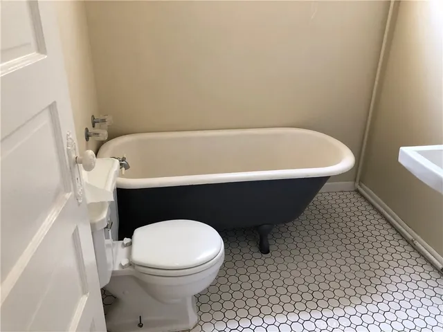a bathroom with a bathtub and a toilet