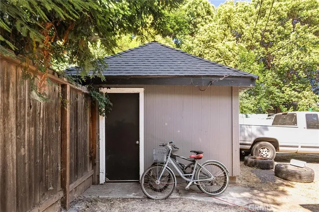 a house view with a backyard space and deck