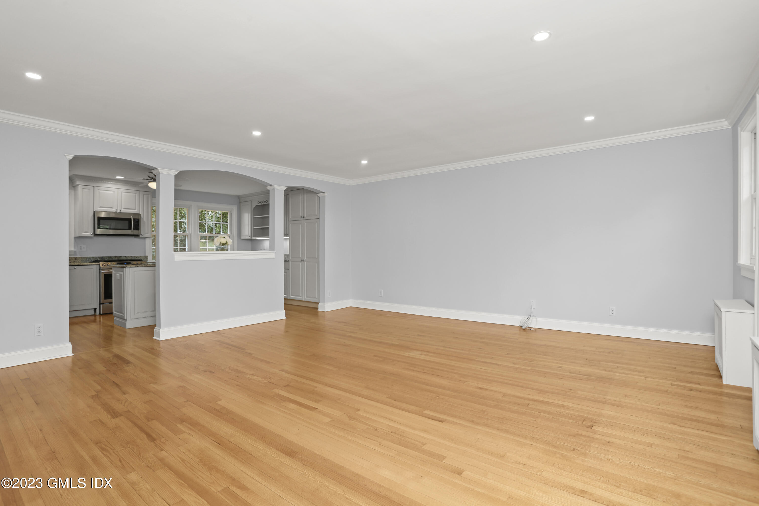 149 Putnam Park, Unit 149 Greenwich, CT 06830 - Photo 11 of 43 a view of empty room with wooden floor and kitchen view
