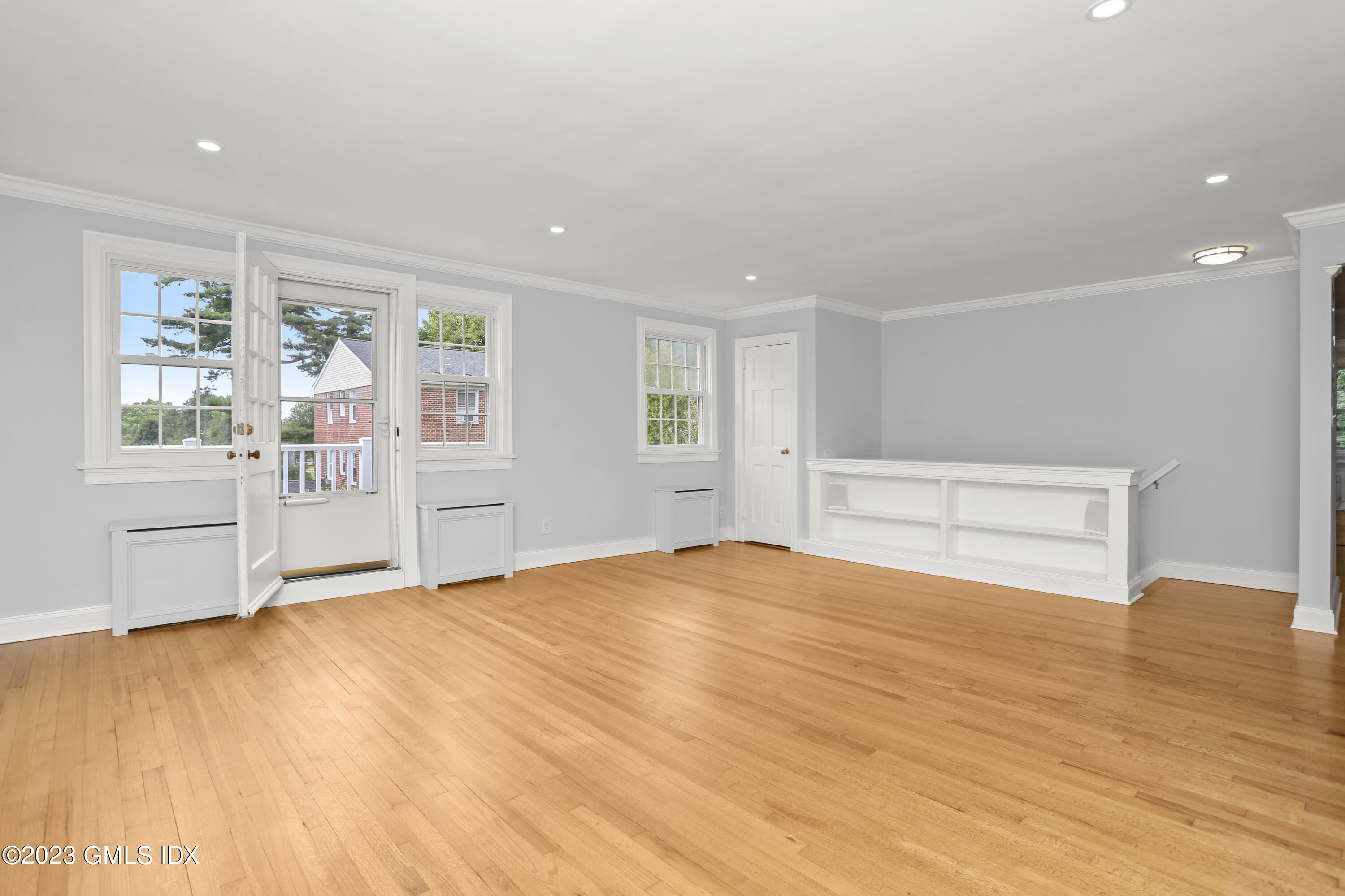 149 Putnam Park, Unit 149 Greenwich, CT 06830 - Photo 13 of 43 a view of an empty room with a window and wooden floor