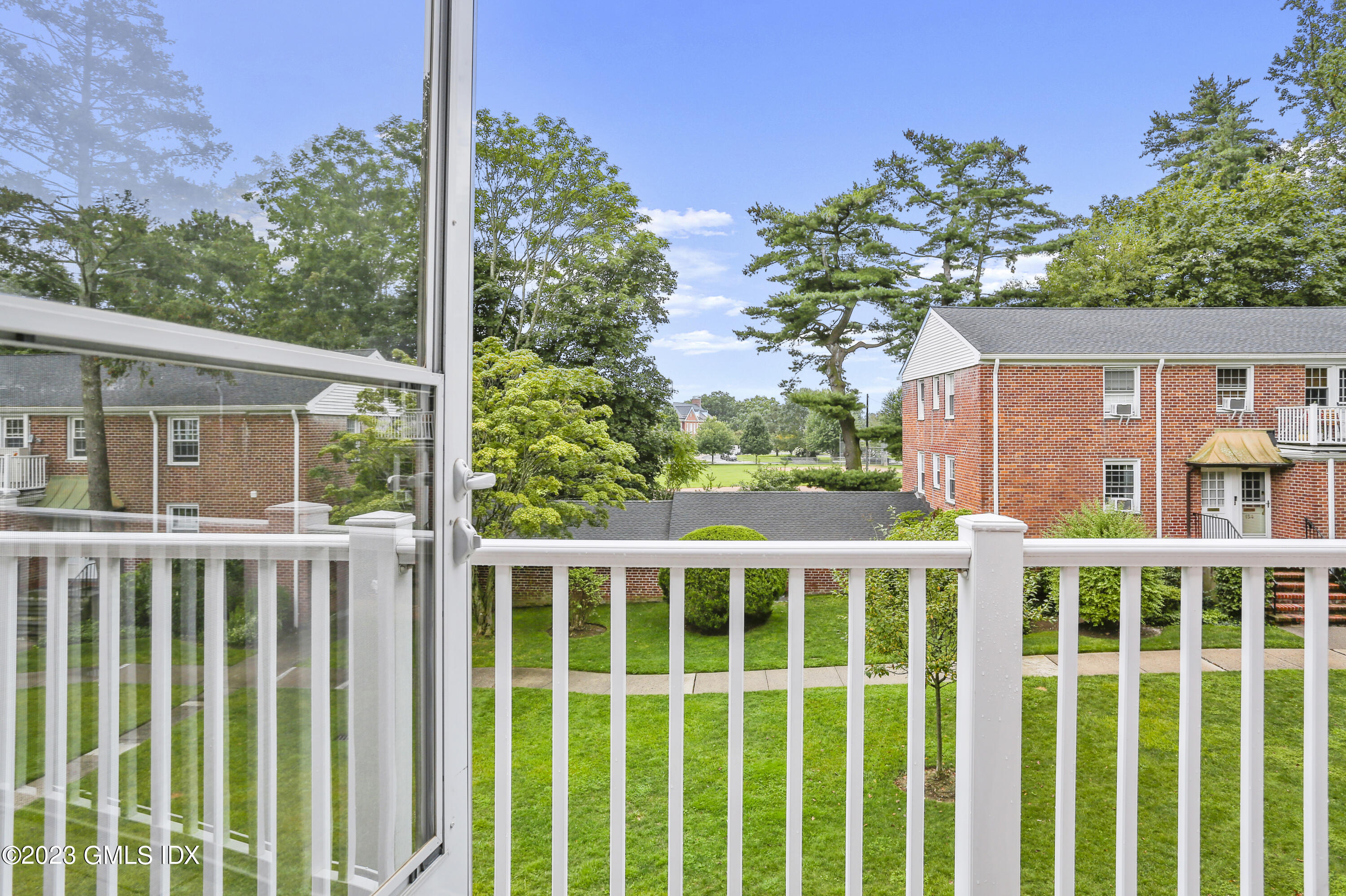 149 Putnam Park, Unit 149 Greenwich, CT 06830 - Photo 14 of 43 a front view of a house with a garden