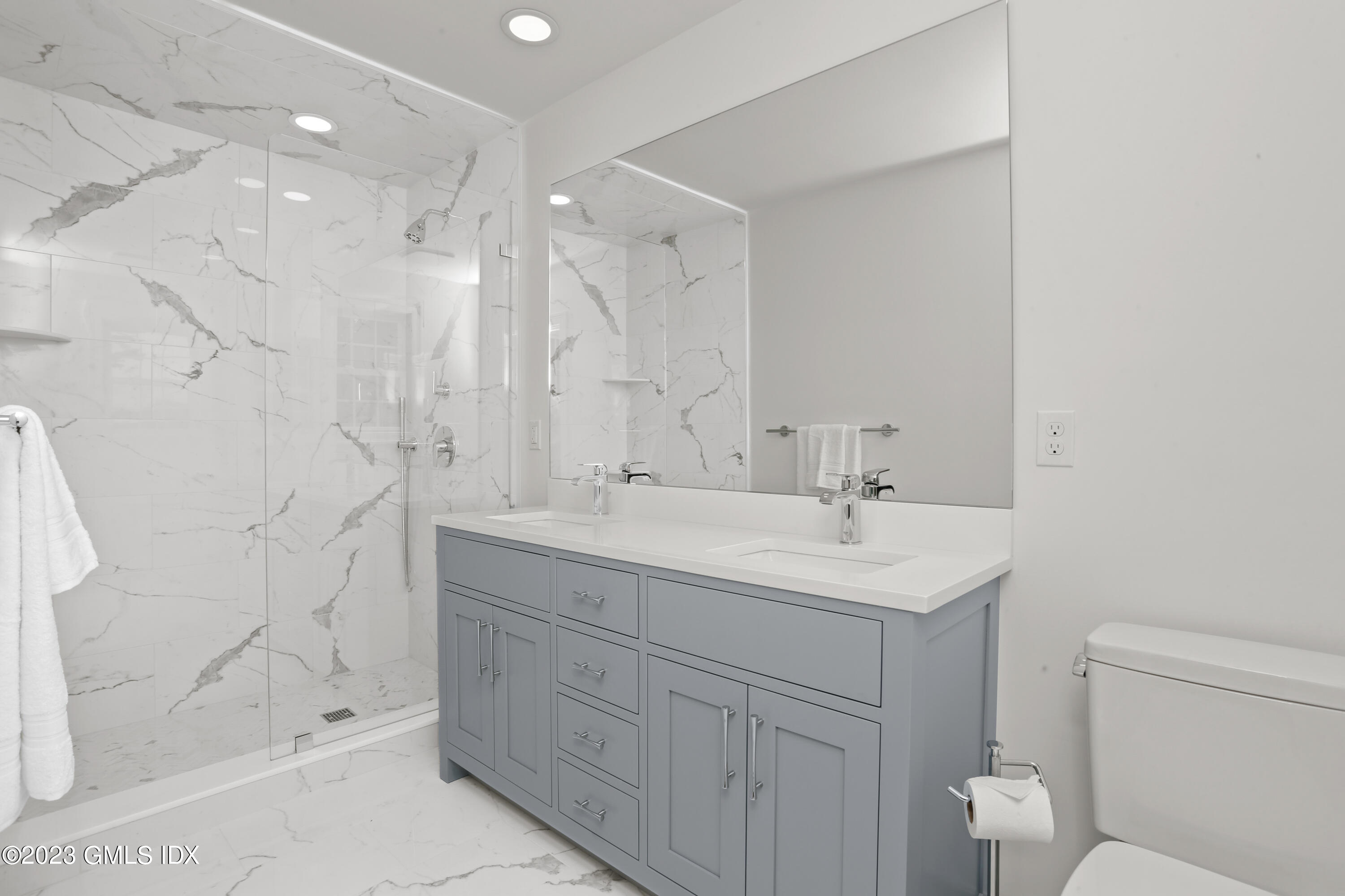 149 Putnam Park, Unit 149 Greenwich, CT 06830 - Photo 20 of 43 a bathroom with a double vanity sink toilet and shower