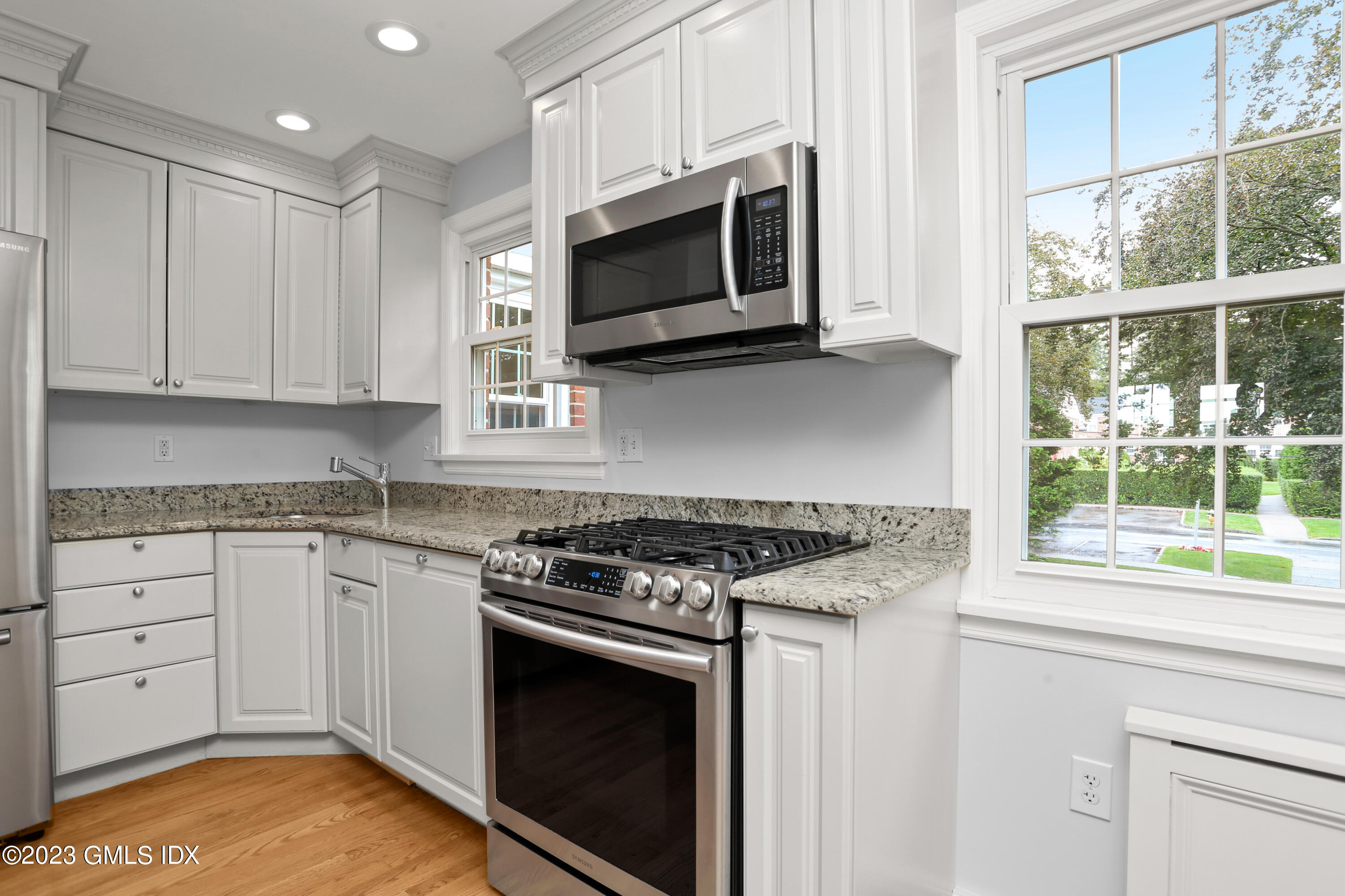 149 Putnam Park, Unit 149 Greenwich, CT 06830 - Photo 3 of 43 a kitchen with stainless steel appliances granite countertop a stove microwave and sink