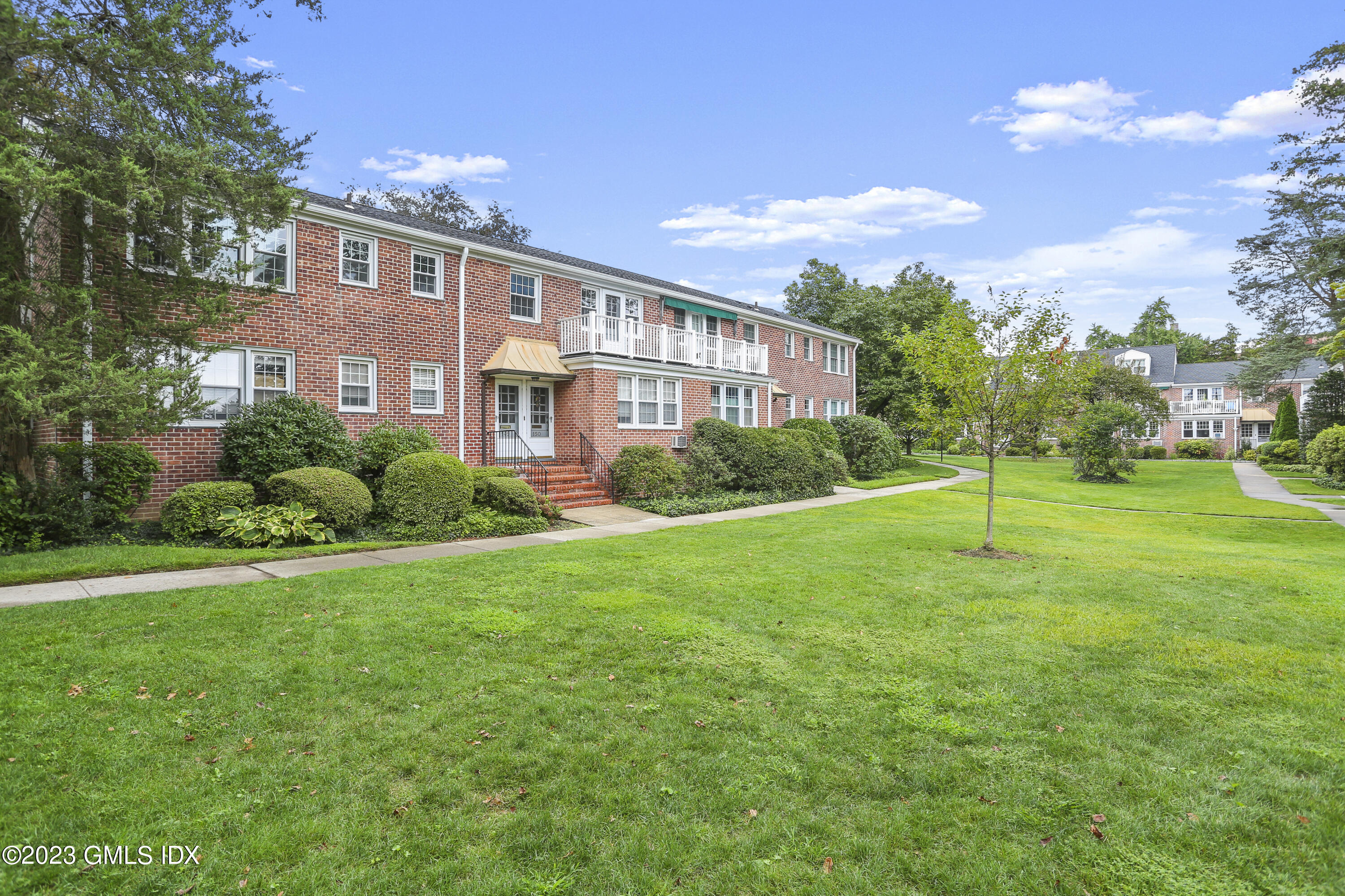 149 Putnam Park, Unit 149 Greenwich, CT 06830 - Photo 38 of 43 a view of a house with a big yard plants and large trees