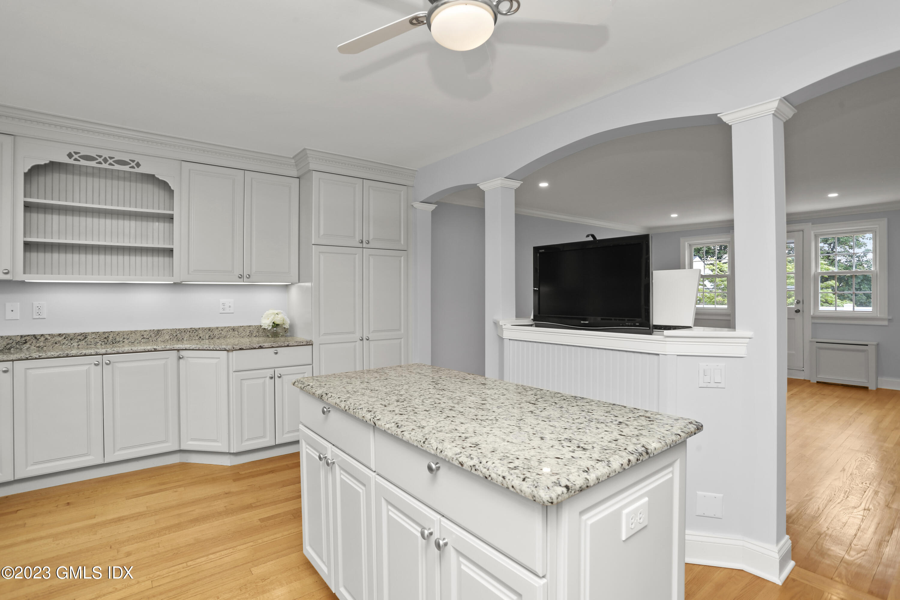 149 Putnam Park, Unit 149 Greenwich, CT 06830 - Photo 5 of 43 a kitchen with kitchen island granite countertop a sink and a stove top oven