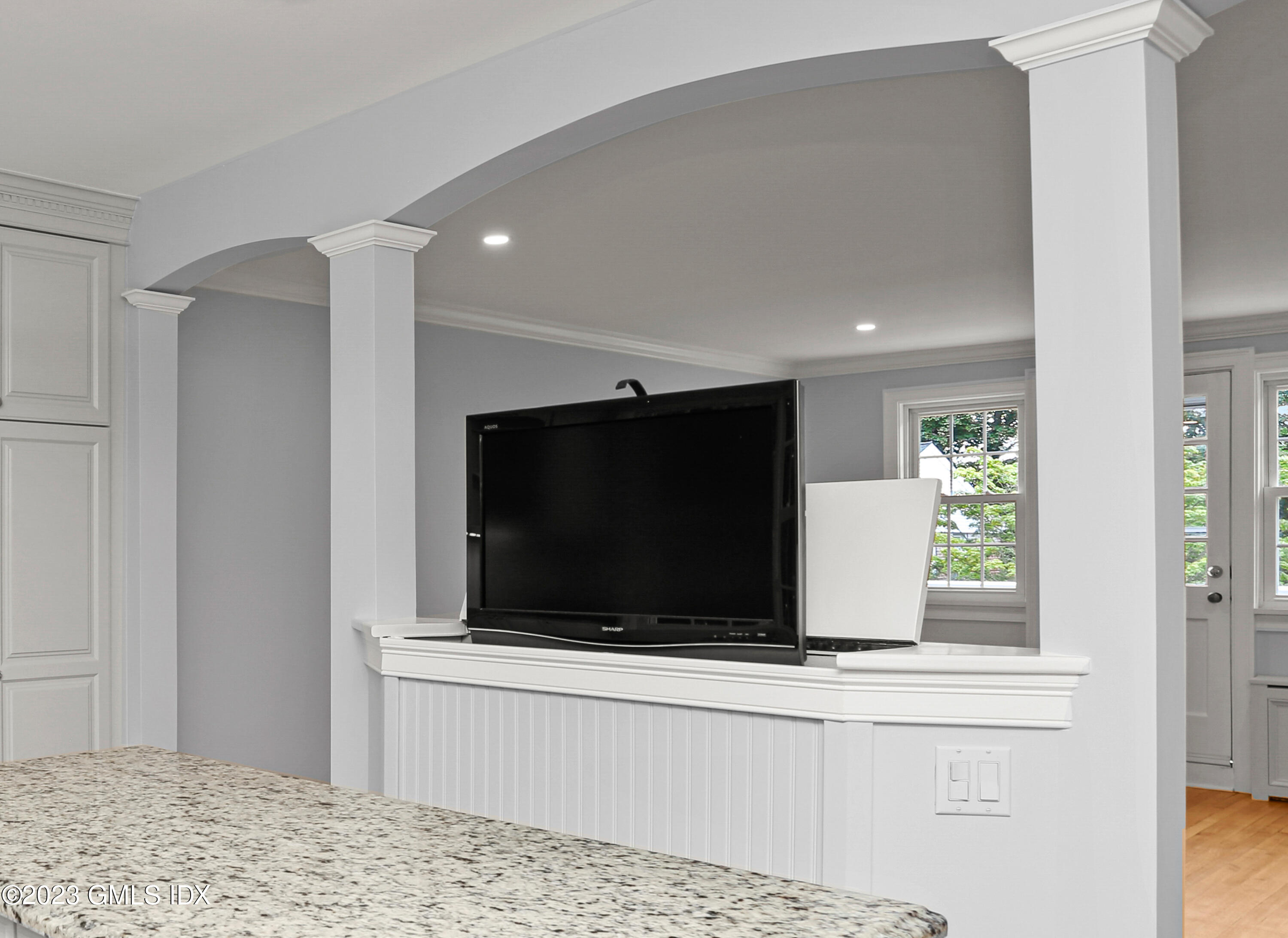 149 Putnam Park, Unit 149 Greenwich, CT 06830 - Photo 6 of 43 a living room with a flat screen tv and a fireplace