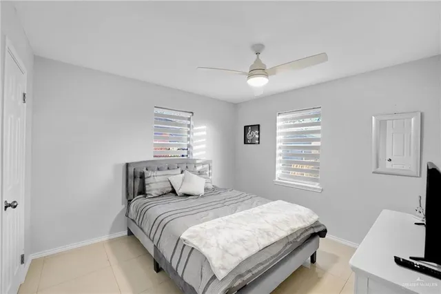 a bedroom with a large bed and a tv