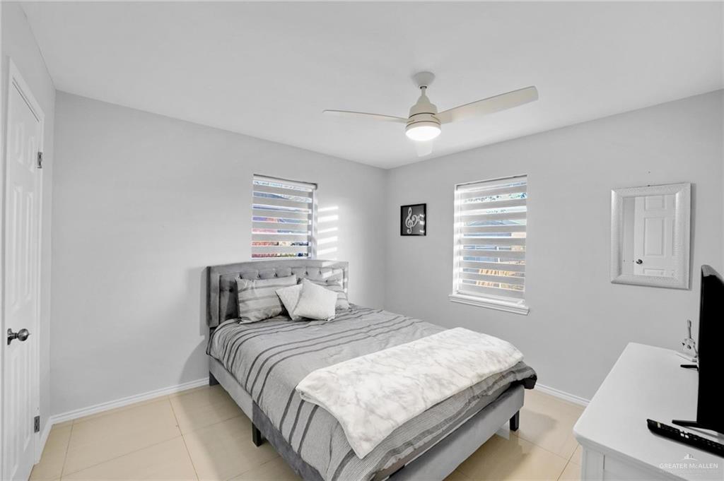 1103 West 26th Street Mission, TX 78574 - Photo 11 of 16 a bedroom with a large bed and a tv