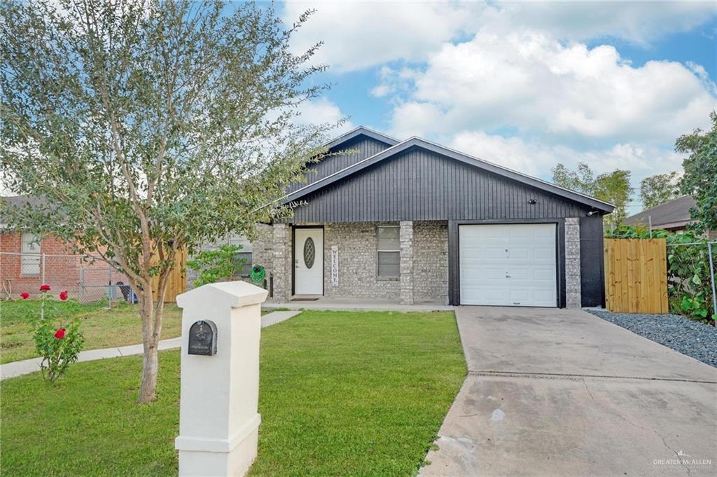 1103 West 26th Street Mission, TX 78574 - Photo 2 of 16 a front view of a house with a yard and garage