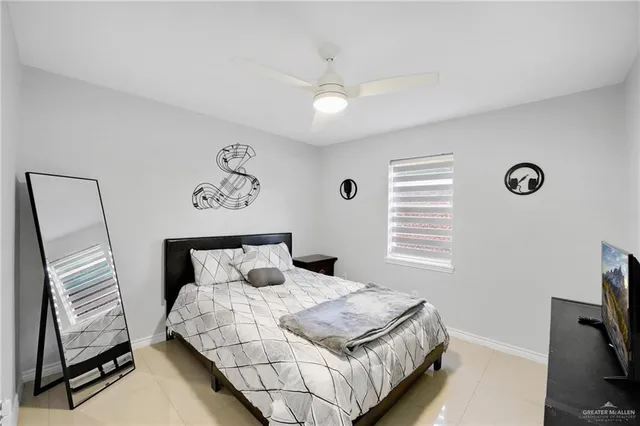 a bedroom with a bed and a television