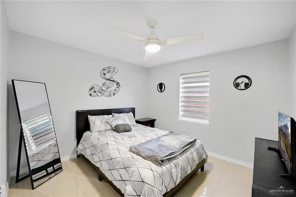 1103 West 26th Street Mission, TX 78574 - Photo 9 of 16 a bedroom with a bed and a television