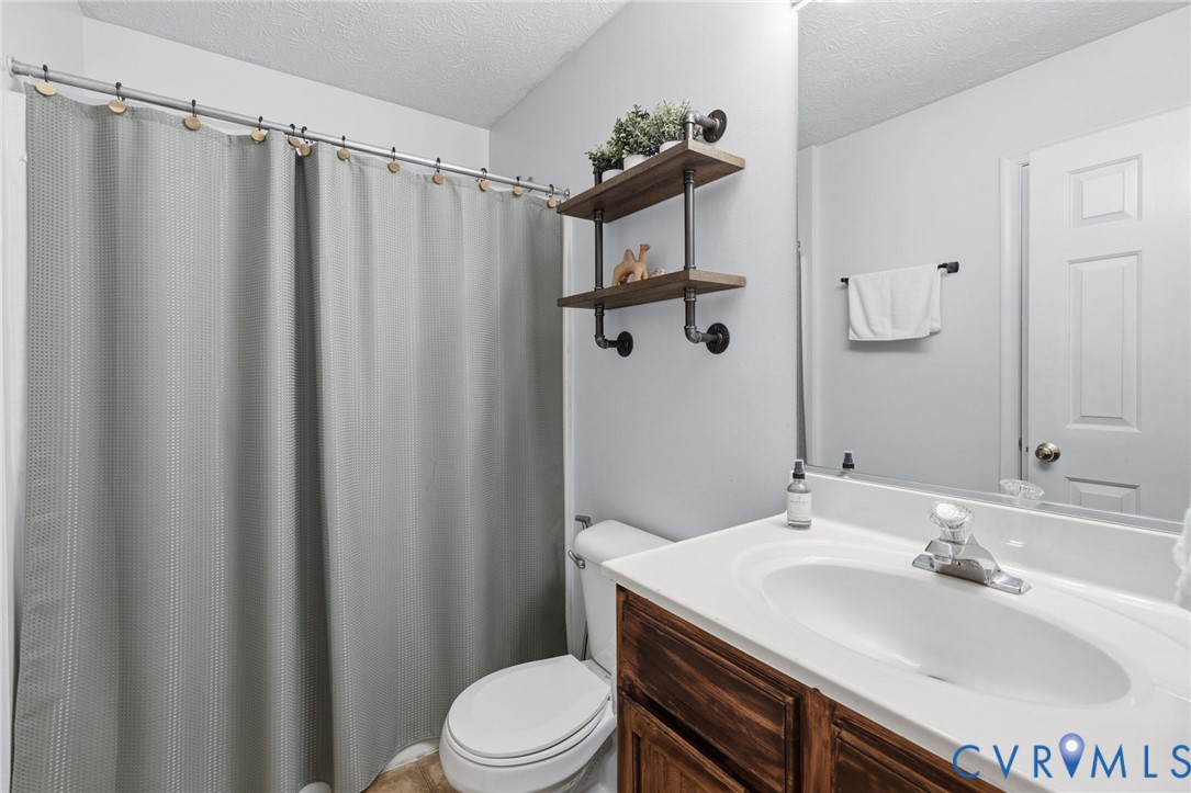 504 Gloucester Drive Ruther Glen, VA 22546 - Photo 13 of 28 a bathroom with a sink a toilet and shower