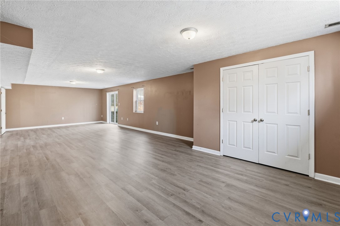 504 Gloucester Drive Ruther Glen, VA 22546 - Photo 17 of 28 a view of empty room with wooden floor