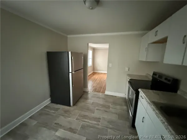 a kitchen with stainless steel appliances a refrigerator and a stove