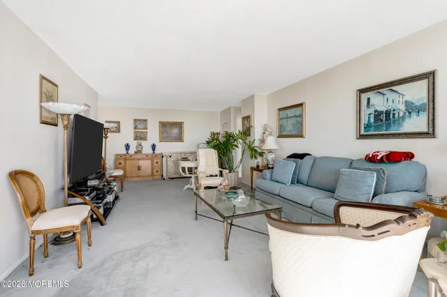 a living room with patio furniture and a flat screen tv