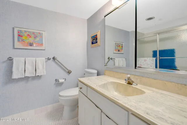 a bathroom with a shower and mirror