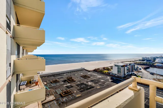 a view of a balcony with wooden floor and fence