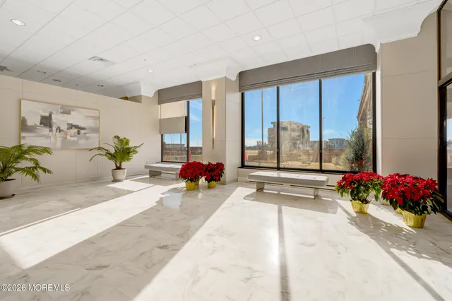 a room with furniture pool table and window