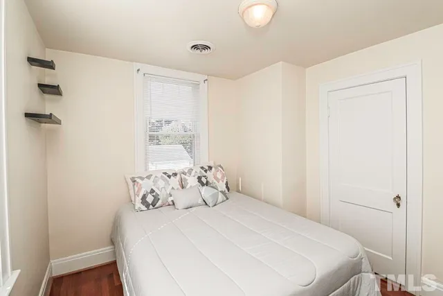 a bedroom with a bed and a window