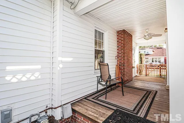 a view of a balcony with wooden bench