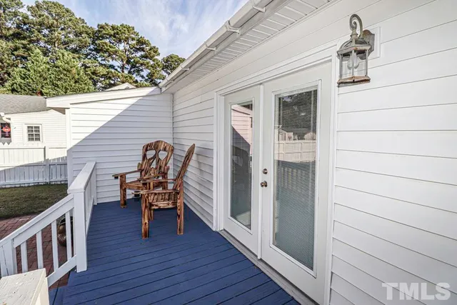 a view of a deck with chair and wooden floor