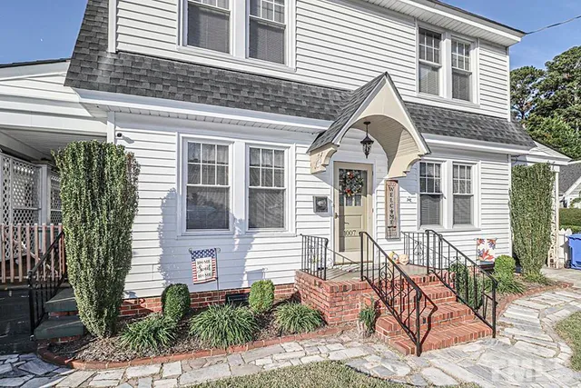 a view of a brick house with large windows and couches