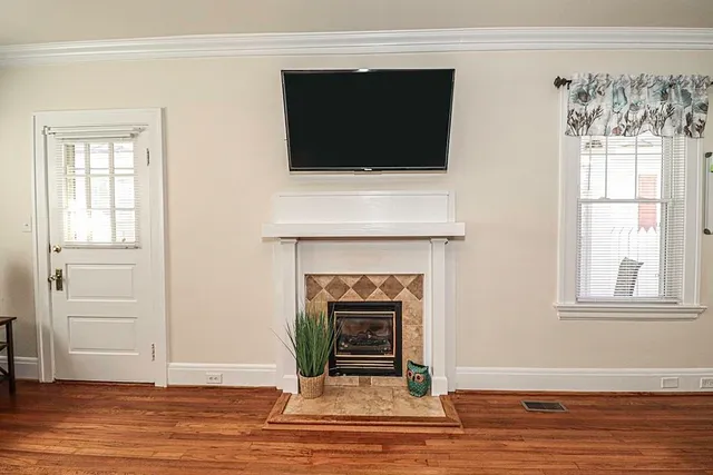 a living room with a fireplace and a flat screen tv