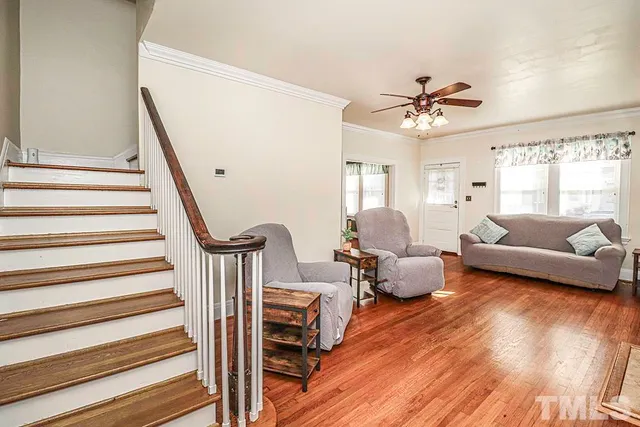 a living room with furniture and a wooden floor