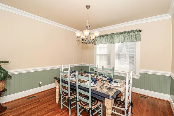 a view of a dining room with furniture and chandelier