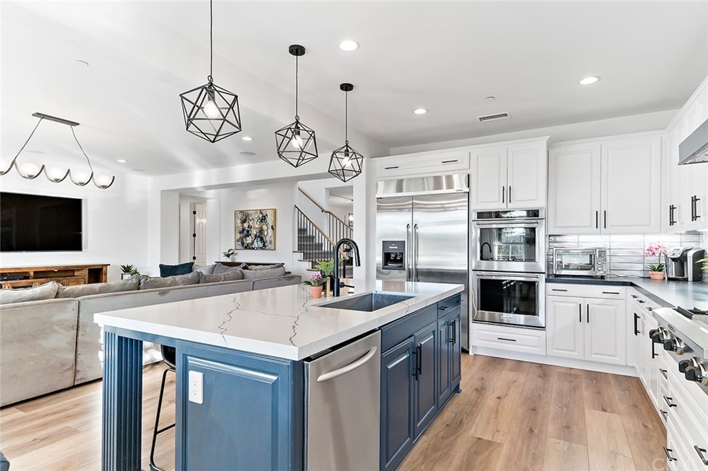 a kitchen with a sink stainless steel appliances and cabinets