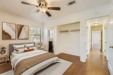 a bedroom with a bed and a painting on the wall