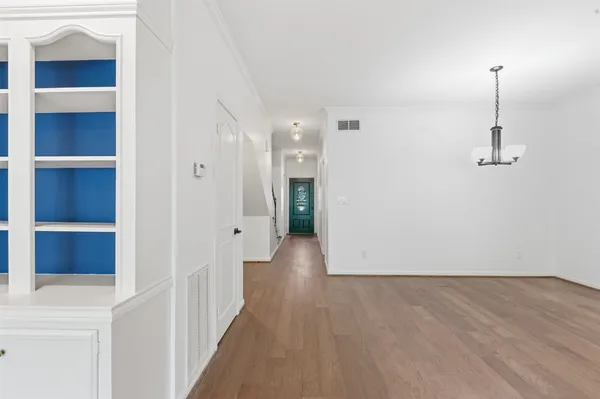 a dining room with furniture and wooden floor