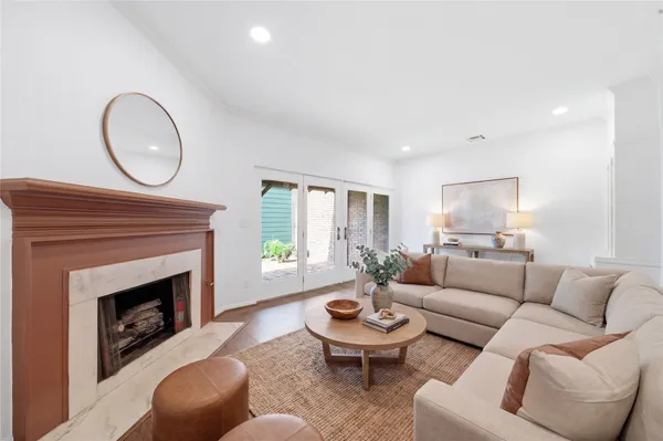 an empty room with wooden floor and a ceiling fan
