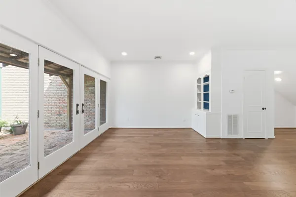 a bathroom with a granite countertop bathtub sink vanity mirror and toilet