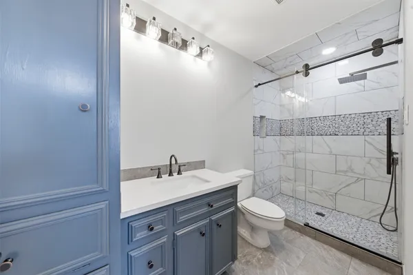 a front view of a house with a tree