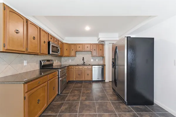 a view of a room with wooden floor and chandelier