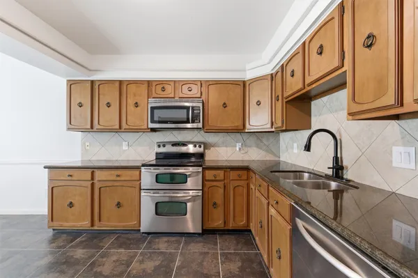 a living room with furniture a fireplace a rug and a window