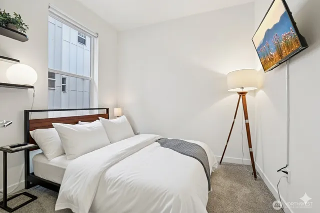 a bed room with a bed and a night stand