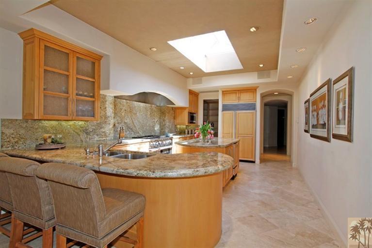 70570 Boothill Road Rancho Mirage, CA 92270 - Photo 11 of 35 a kitchen with kitchen island a stove a sink and a refrigerator