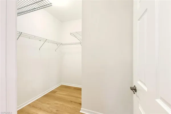 a spacious bathroom with a double vanity sink a large mirror and shower