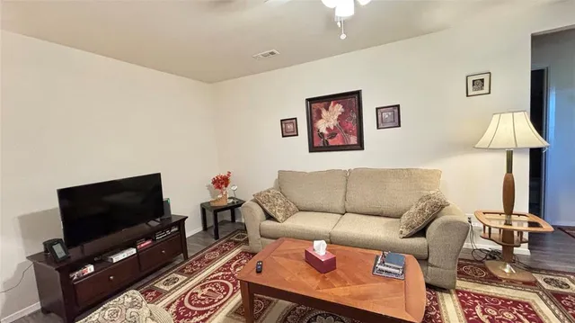 a living room with furniture and a flat screen tv